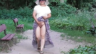 Wife in transparent dress in public park